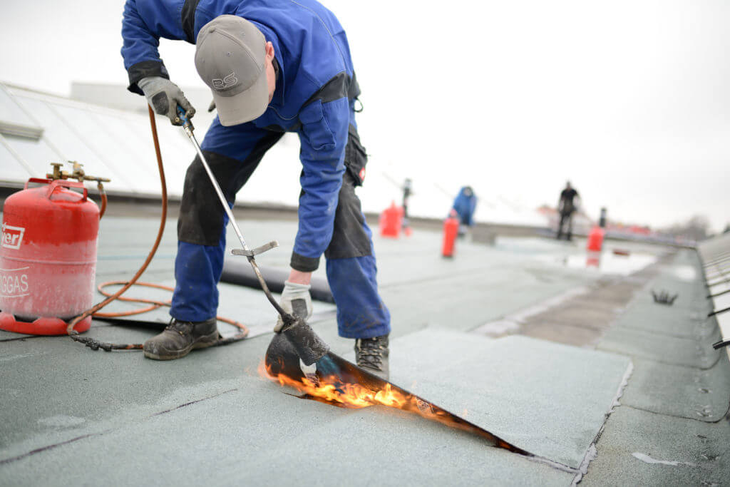 demonstration of flat roof repair service by Central Roof done