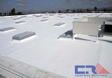 White industrial roof with skylights and air conditioning unit
